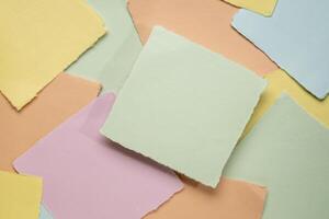 background of random square art paper notes in pastel colors photo