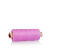 skein of thread pink colors macro on a white background photo