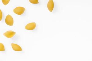 Pasta products in the form of a shell, texture, on a white background photo