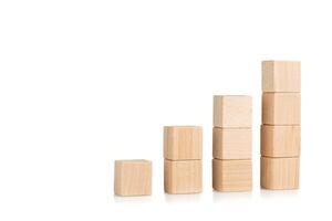 wooden cubes in the form of a ladder with a hand on an isolate white background photo