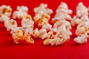 box with popcorn on a red background photo