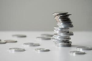 Currency coins are stacked irregularly on the table photo