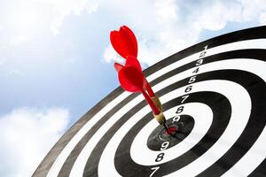 Two arrows on target board with sky background photo