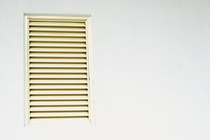 window with shutters on white wall with copy space photo