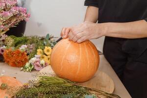 Creating a floral composition in a pumpkin. Making decor with your own hands. photo