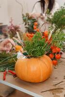 Creating a floral composition in a pumpkin. Making decor with your own hands. photo