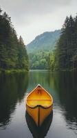 Canoeing on a peaceful lake surrounded by autumn trees under a cloudy sky photo