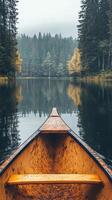 Canoeing on a peaceful lake surrounded by autumn trees under a cloudy sky photo