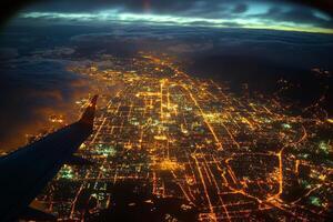Vibrant city skyline illuminated at night with winding river and dramatic clouds photo