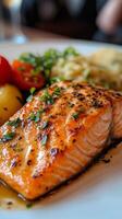 Delicious grilled salmon served with quinoa and fresh vegetable salad on a rustic plate photo