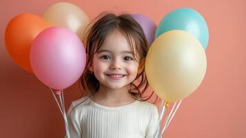 Smiling child holding colorful balloons against a pastel background in a cheerful atmosphere photo