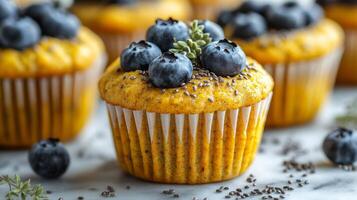 Fresh blueberry muffins topped with berries and chia seeds on a dark background photo