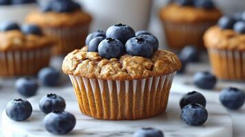 Fresh blueberry muffins topped with berries and chia seeds on a dark background photo
