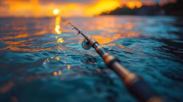 Close-up of a fishing rod with droplets resting on its surface near calm water photo