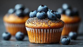 Fresh blueberry muffins topped with berries and chia seeds on a dark background photo