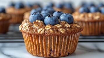 Fresh blueberry muffins topped with berries and chia seeds on a dark background photo