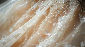 Elegant bridal gown adorned with delicate white flowers in a soft fabric setting photo