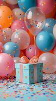 Colorful gift box surrounded by balloons and confetti at a festive celebration photo