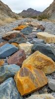Colorful collection of smooth stones arranged on a natural surface in bright sunlight photo