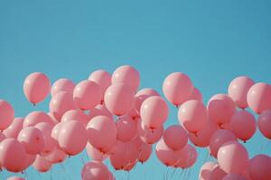 Pink balloons float against a bright blue sky with fluffy white clouds in a joyful outdoor setting photo