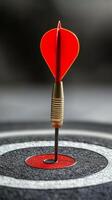 Dart with heart-shaped tip hitting the center of target in a serene blue water background photo