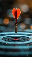 Dart with heart-shaped tip hitting the center of target in a serene blue water background photo
