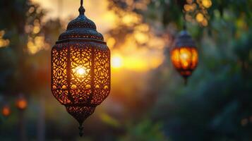 Lantern glowing in twilight with intricate patterns surrounded by lush greenery and warm sunset light photo