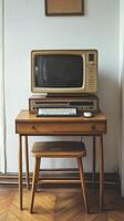 Vintage computer setup with monitor and keyboard on a wooden desk photo