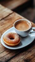 Morning coffee and donut on rustic wooden table with heart latte art photo