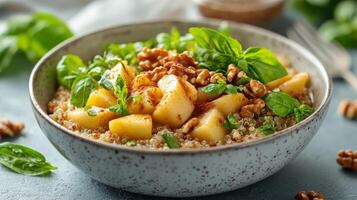 Warm apple and pecan quinoa bowl served with cinnamon and nutmeg for breakfast or snack photo
