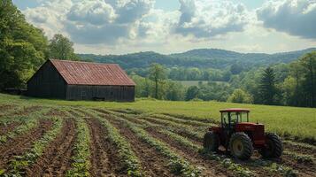 Red barn and tractor in lush green farm landscape on a sunny day photo
