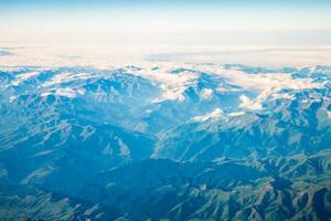 A view of the planet Earth, a view from an airplane, mountains and clouds photo