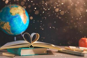 books, stationery on the table on a black chalkboard. Education, September 1, new academic year photo