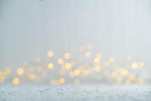 Blurring golden christmas lights against a shimmering silver background creates a magical and festive atmosphere, perfect for celebrating the holiday season with warmth and joy photo