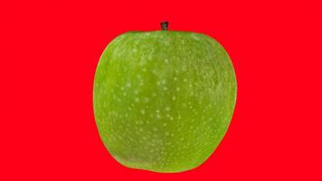 green apple with red background photo