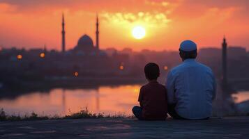 Father and son praying together by the water at sunset in Istanbul photo