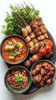 Grilled Meat Skewers with Spicy Dips and Garnishes photo