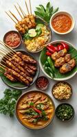 An Assortment of Thai Dishes Featuring Skewers, Curry, and Rice photo