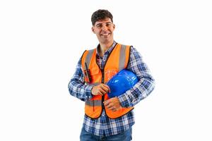 Engineer in orange safety vest smiling at the camera while holding blue helmet under arm photo