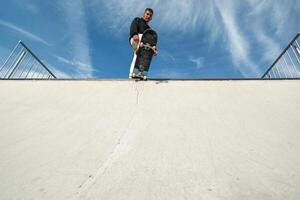 copyspace Fish-eye view of a skater looking impressive at the edge of the half pipe photo