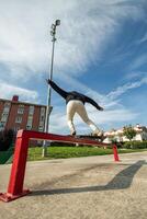 Fish-eye view of a skater grinding a rail from behind in the skate park photo