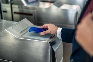 copyspace closeup a businessman hand using contactless mobile payment to access the metro station photo