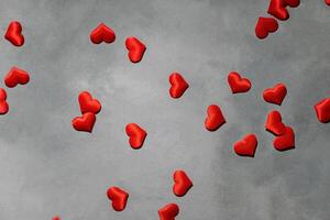 Red hearts on a gray background. Background for a postcard photo