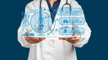 A doctor in uniform holding a tablet with a report on health patients on a virtual screen while standing on a blue background photo