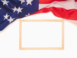 Top view of the American flag and empty mini whiteboard on a white background photo
