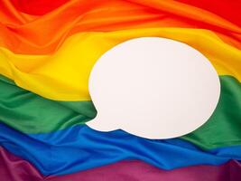 Top view of rainbow flag or LGBT flag with a blank white speech bubble photo