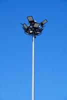 Tall Street Light Pole Against Clear Blue Sky on a Sunny Day Capturing Urban Infrastructure and Minimalist Design photo