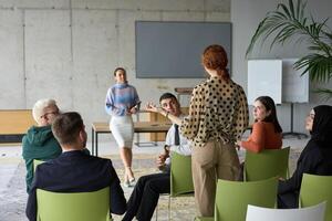 A diverse group of business professionals sits attentively in a modern office, actively participating in a training session led by an instructor, focusing on the latest technological advancements in photo