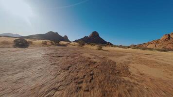 Mountains in sandy desert view from FPV drone video