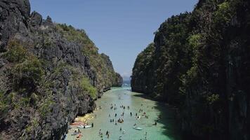 POV drone inder in a big lagoon under canoes in palawan, fpv flight video
